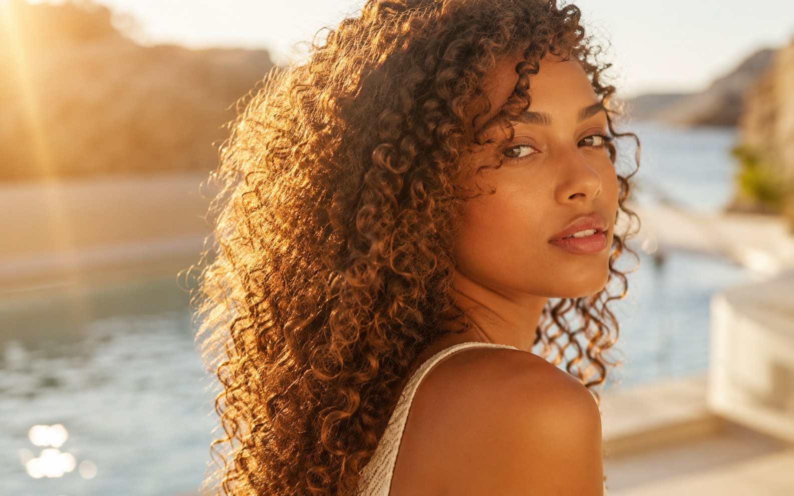 Curly hair protected in the sun by the sea